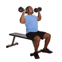 Man exercising with dumbbells for upper body weight workouts on a weight bench against a white background