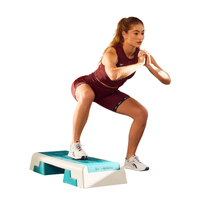 Woman exercising on a step platform against a white background