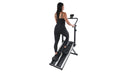 Woman using a stair stepper machine on a white background