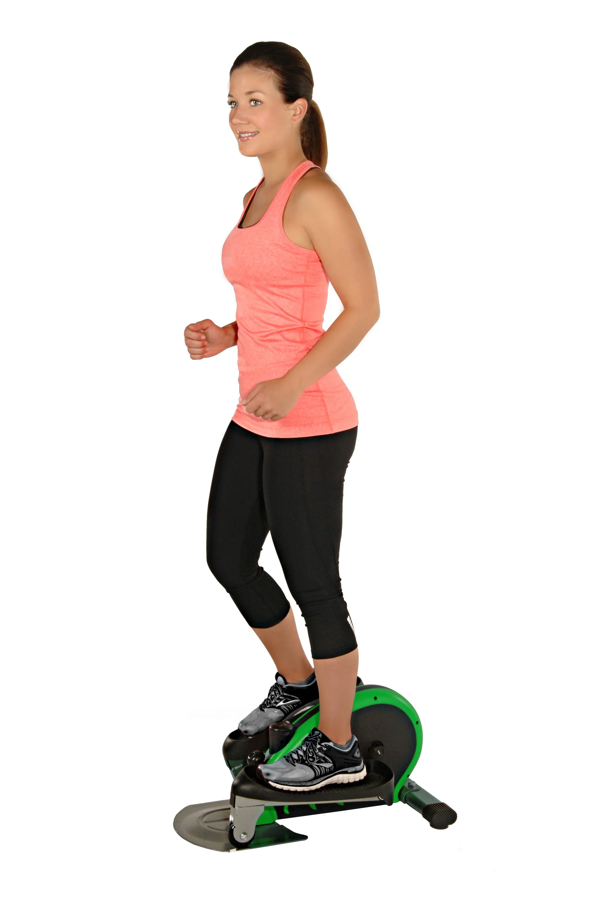 Woman using a green exercise bike on a white background