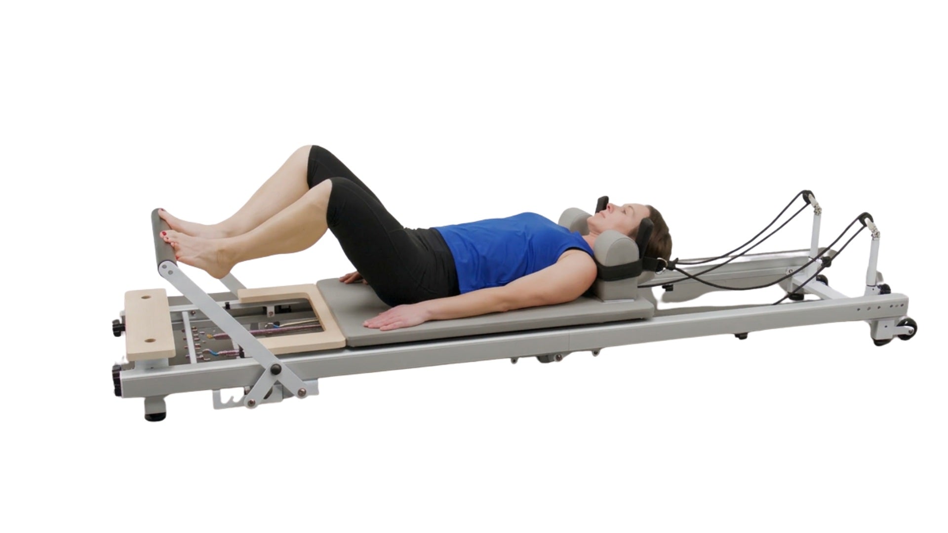 Pilates reformer machine on a white background for strength training, flexibility model image