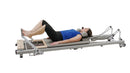 Pilates reformer machine on a white background for strength training, flexibility model image