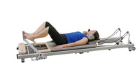 Pilates reformer machine on a white background for strength training, flexibility model image
