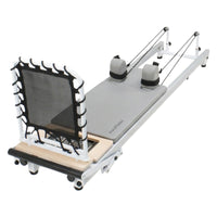 Pilates reformer machine on a white background for strength training, flexibility main image