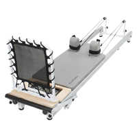 Pilates reformer machine on a white background for strength training, flexibility main image