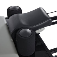 AeroPilates Premier Studio 701 Close-up of a black leather armrest on a vehicle seat with a white background