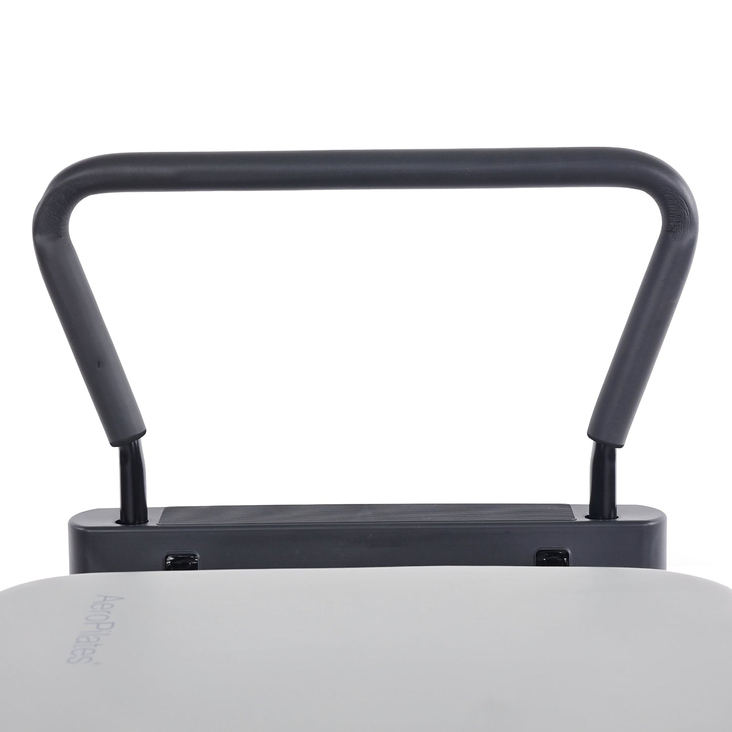 AeroPilates Premier Studio 701 Close-up of a black handle on a white surface with a brand name.