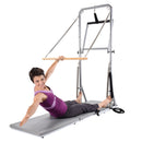 Woman using a Pilates reformer machine on a white background