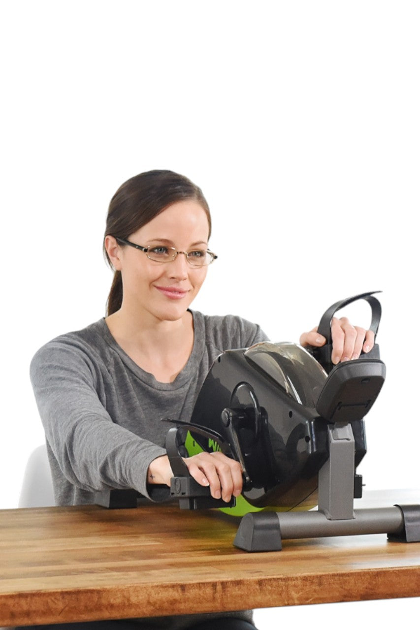 Compact Stamina WIRK exercise bike tucked under a standard office desk for silent calorie burning while working, life style