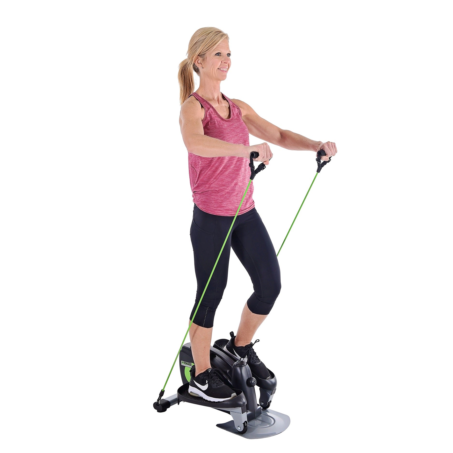Woman exercising on a step machine with resistance bands on a white background