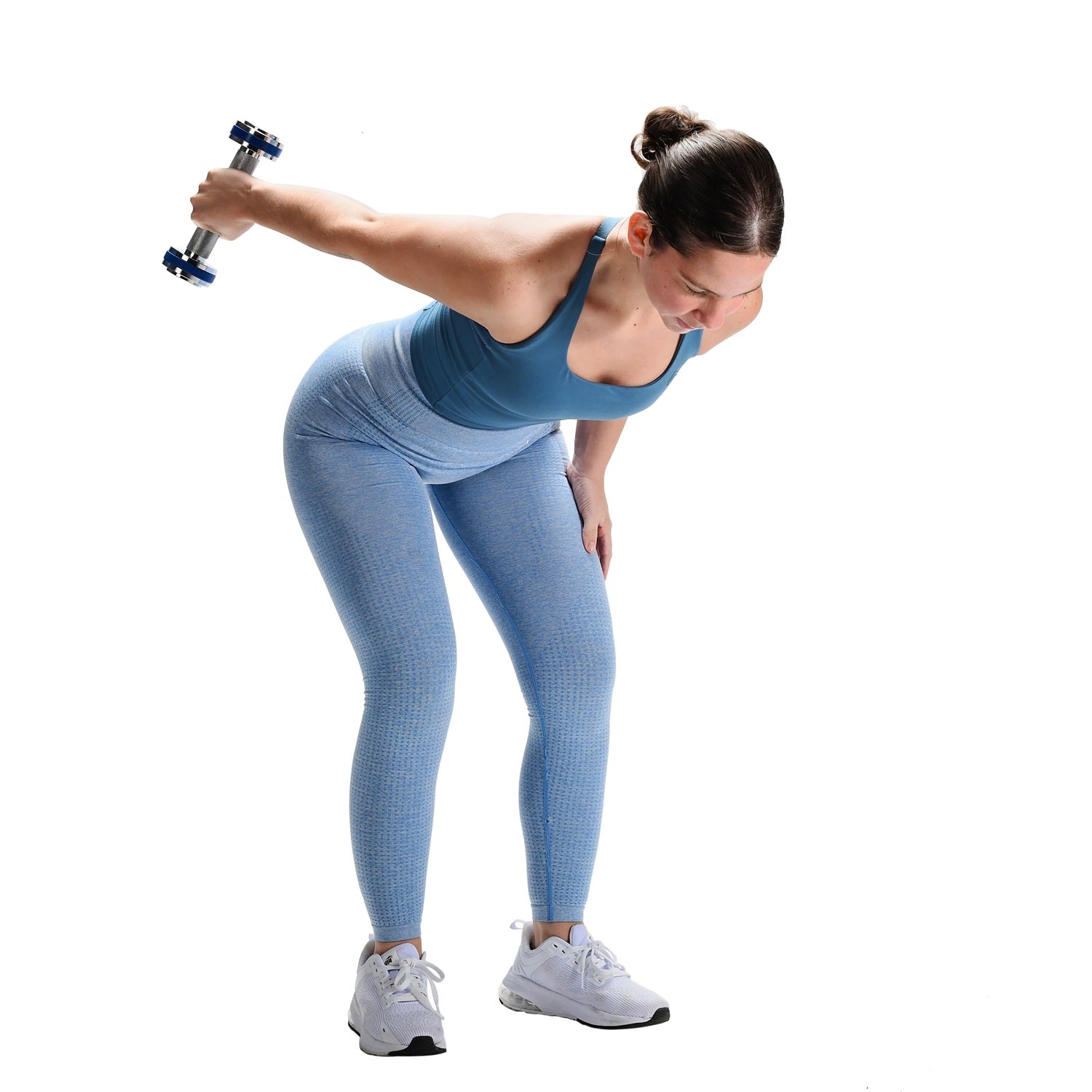 Woman exercising with a dumbbell on a white background
