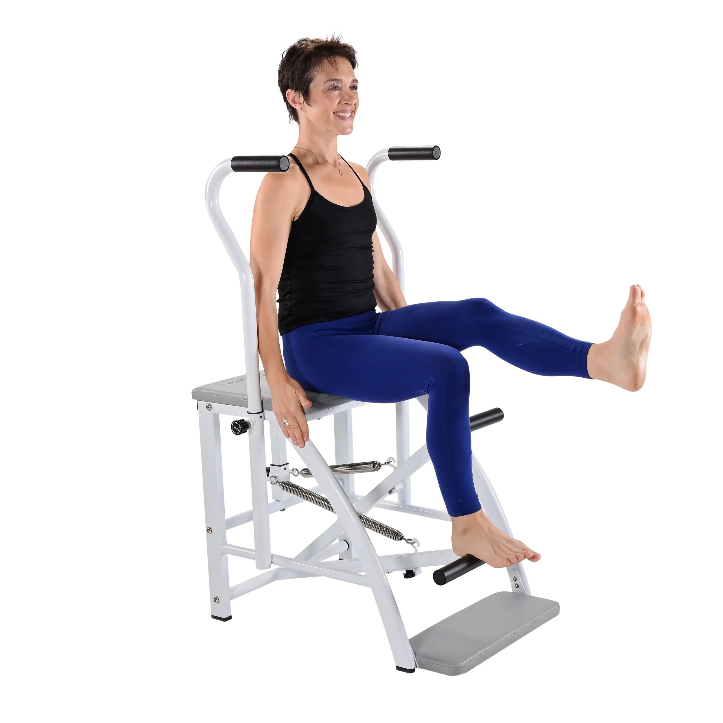 Woman using a low impact strength training machine on a white background