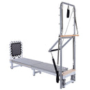 Pilates reformer machine with attachments on a white background