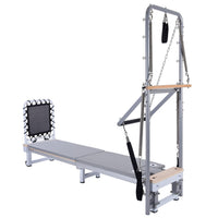 Pilates reformer machine with attachments on a white background