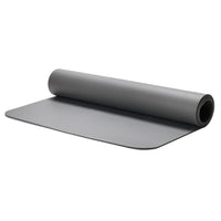 Gray for exercise equipment mat rolled up on a white background