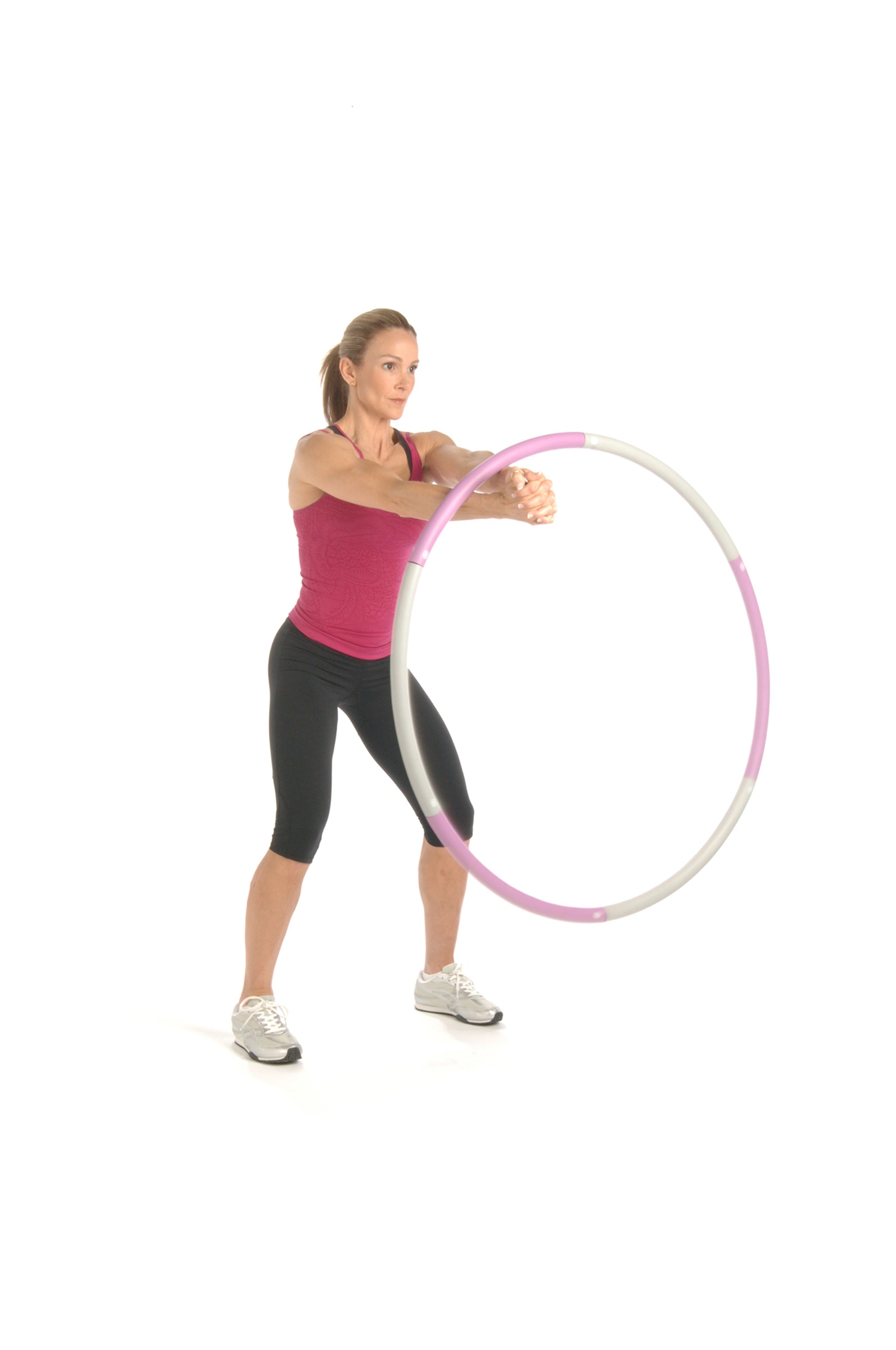 Woman holding a pink and white hula hoop on a white background