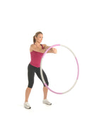 Woman holding a pink and white hula hoop on a white background