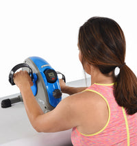 Woman using a blue and gray exercise bike on a white background