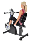 Woman using a recumbent exercise bike on a white background