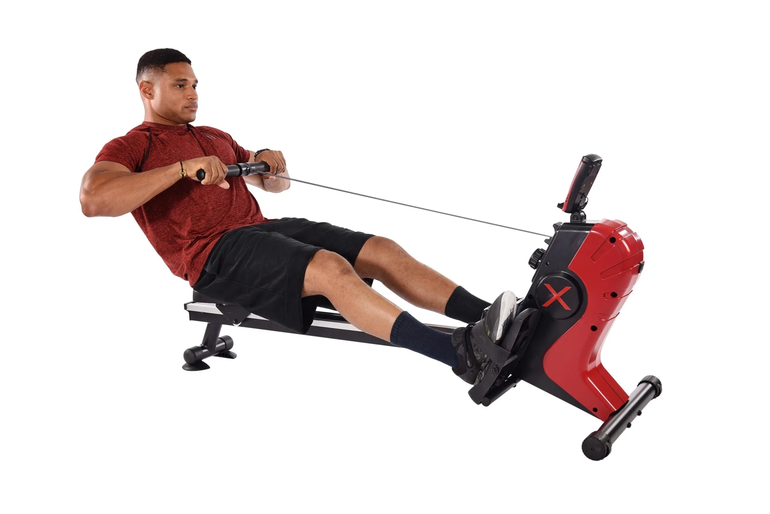 Man using a red and black portable rowing machine on a white background