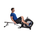 Man using a recumbent bike exercise equipment on a white background