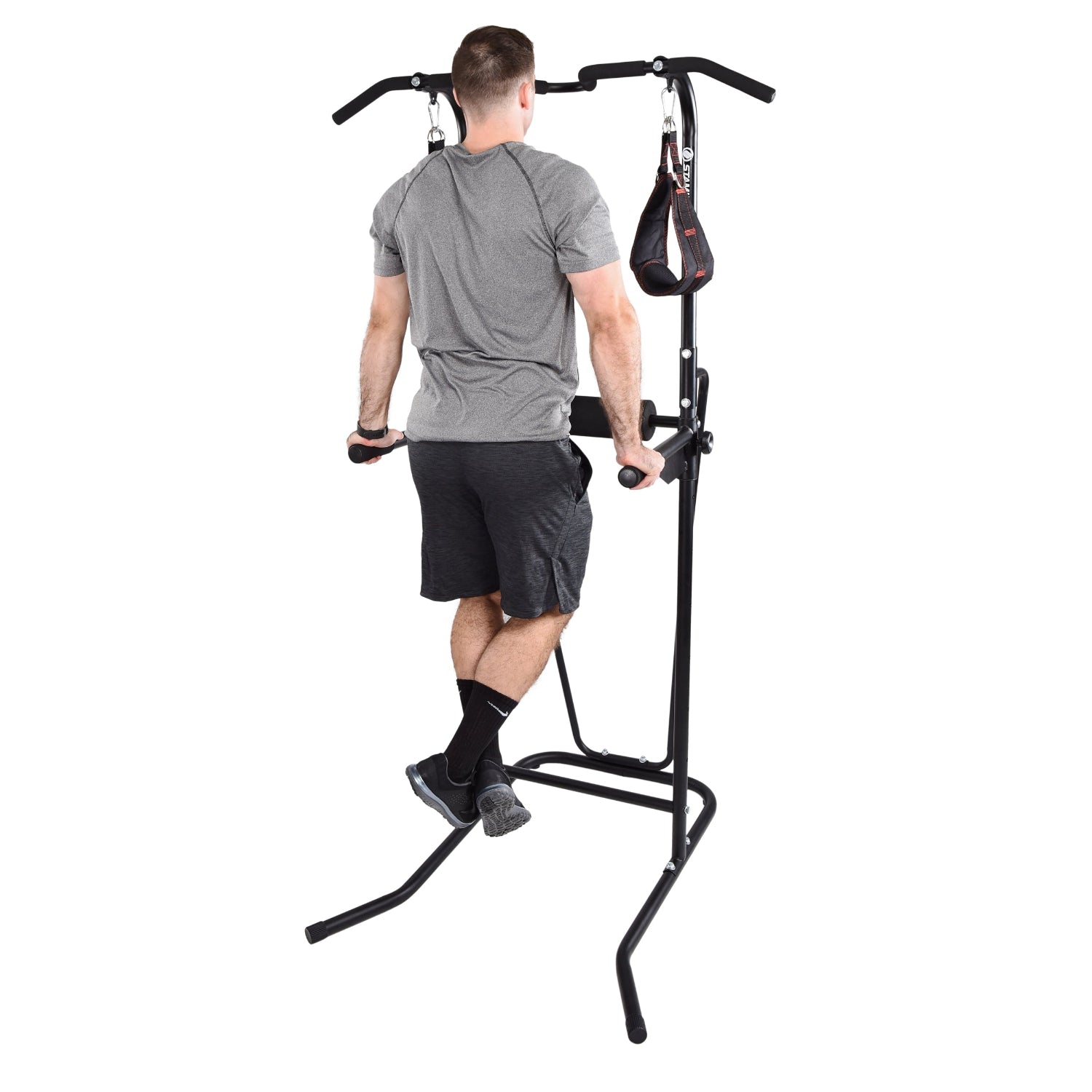 Person using a black Stamina Power Tower 1698 on a white background