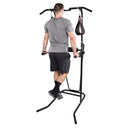 Person using a black Stamina Power Tower 1698 on a white background