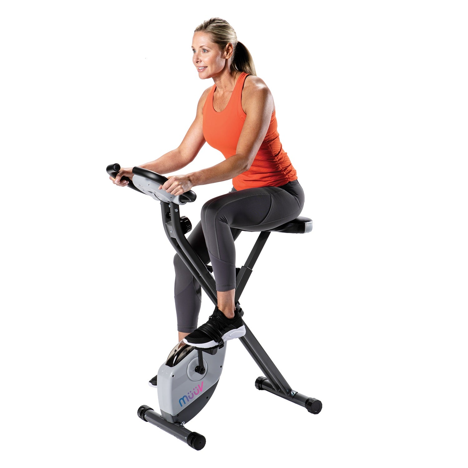 Woman exercising on a stationary bike with a white background