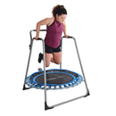 Woman exercising on a small trampoline with a stand on a white background