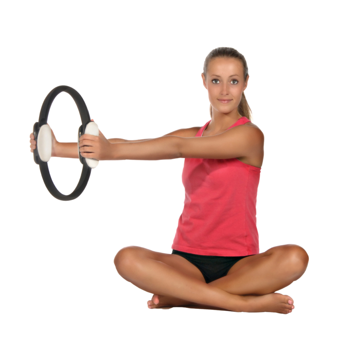 Woman seat workout on AeroPilates Magic Circle with DVD