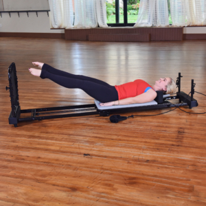 Woman lying down and performing cardio rebounder.