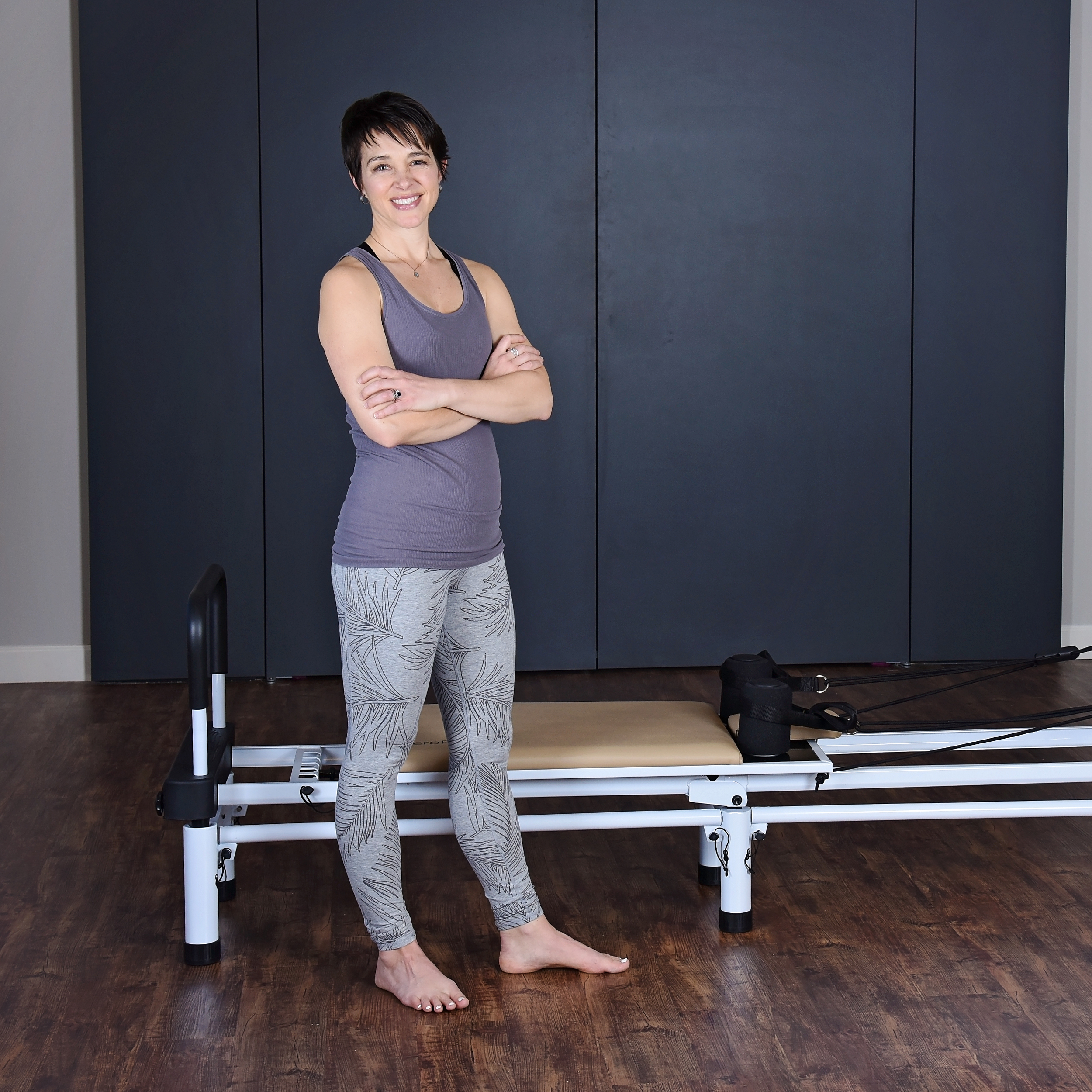 Woman standing in front of Full Body AeroPilates Workout.