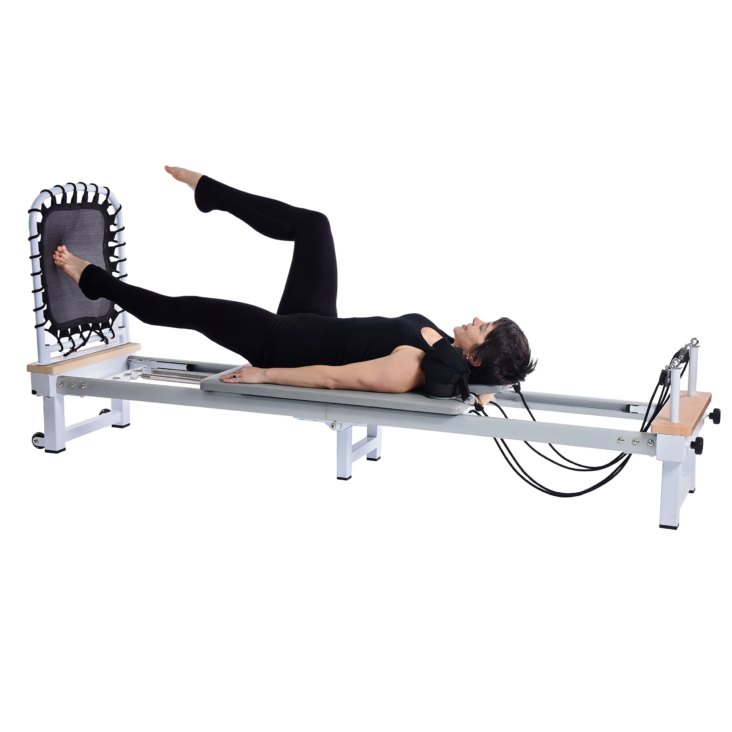 Short hair woman lying down and doing cardio rebounder.