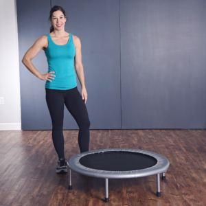Woman standing and holding her hips beside on Fitness Trampoline.