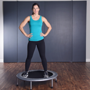 Woman standing on top of Fitness Trampoline.