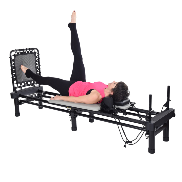 Woman lying down on pilates and bent her leg upward.