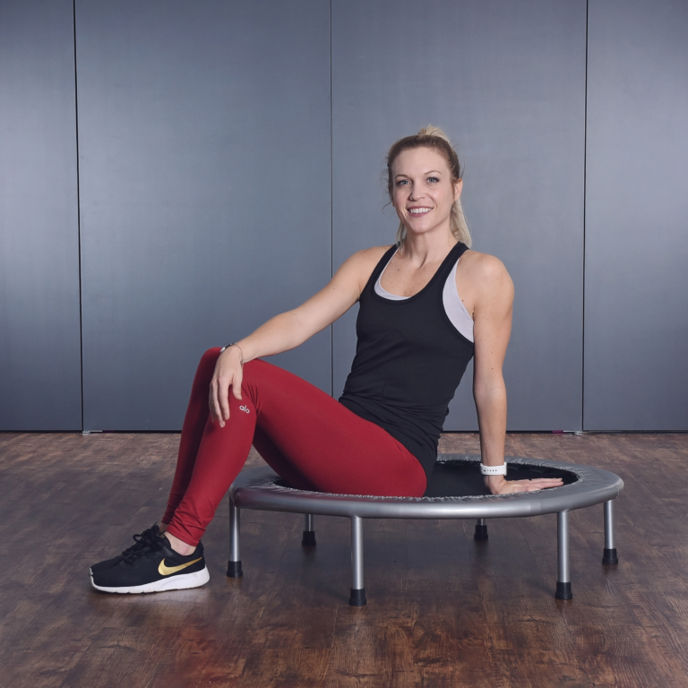 Woman seated on Fitness Trampoline.