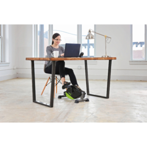 Woman working out at desk with exercise machine