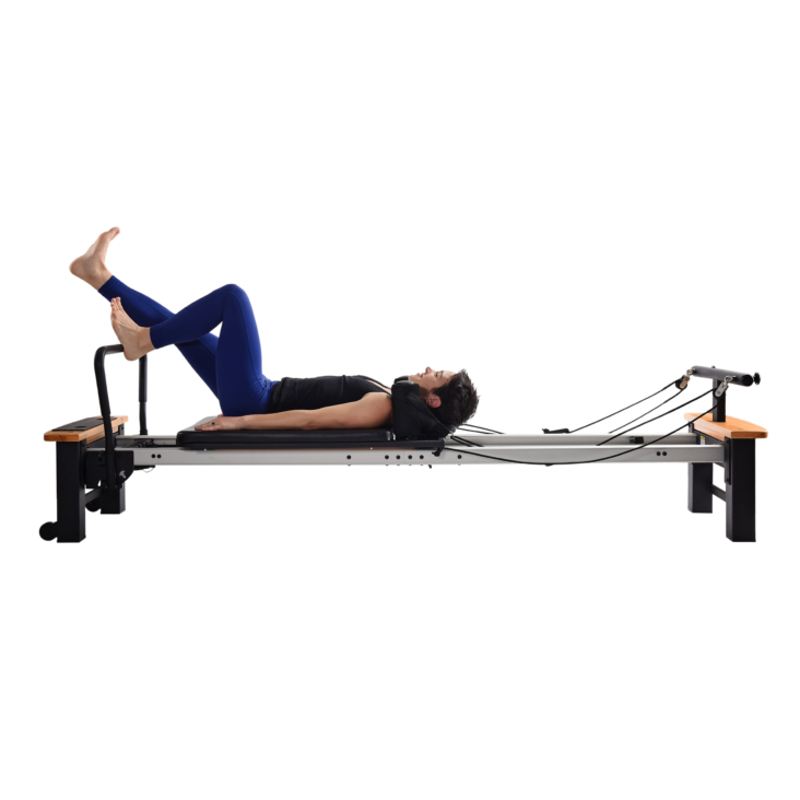 Woman workout on padded Reformer Footbar
