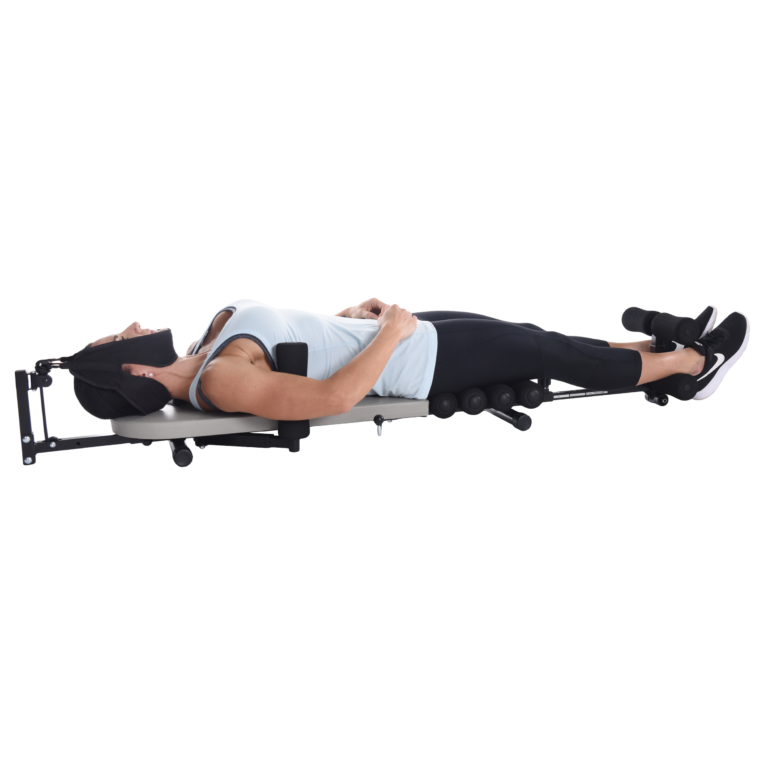 Woman lying down on Stamina InLine Back Stretch Bench while her neck strech.