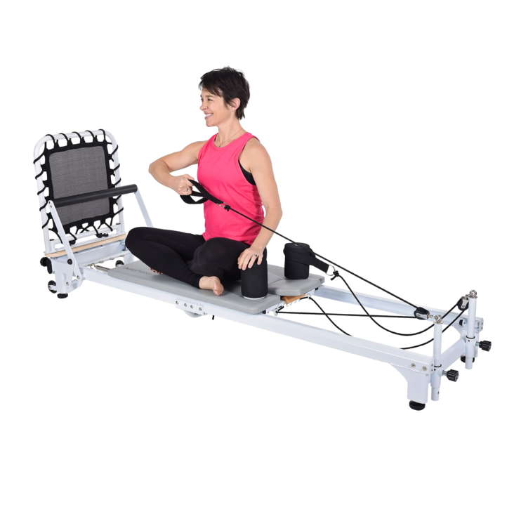 Woman seat and workout her arm on Aeropilates Reformer 608 Footstraps