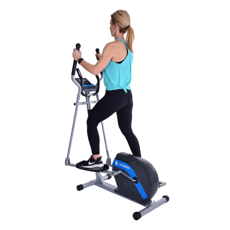 Middle age woman exercising her legs on Stamina Elliptical Trainer 703
