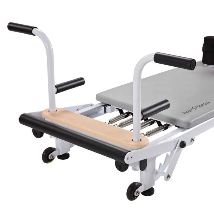 Close up of side view of metal pilates equipment with handles