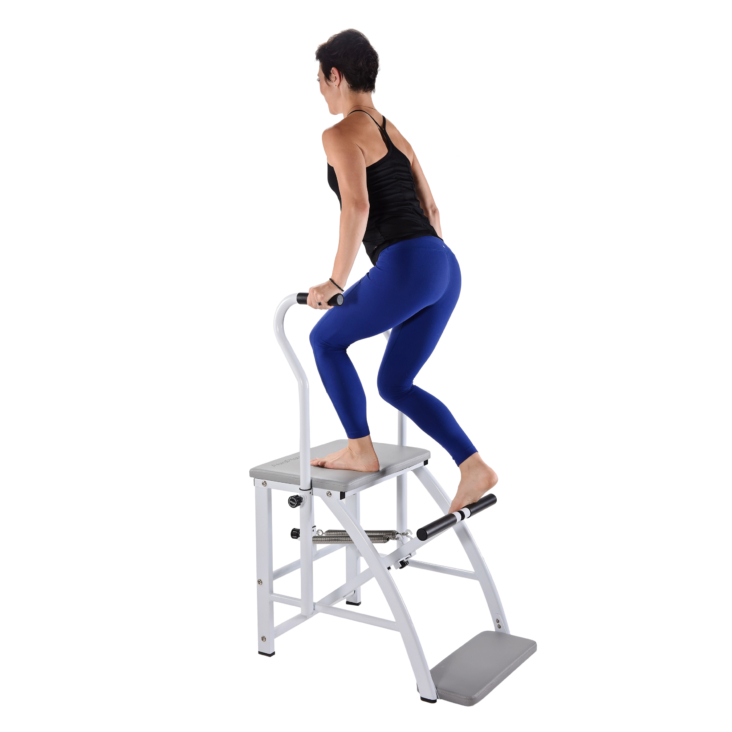Standing woman with knees bent on pilates chair