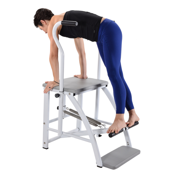 Woman facing downward arms straight on pilates chair