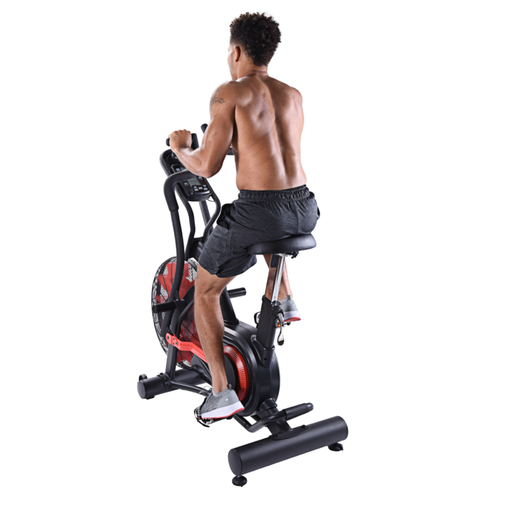 Man seated on Air Bike Exercise in a back view.