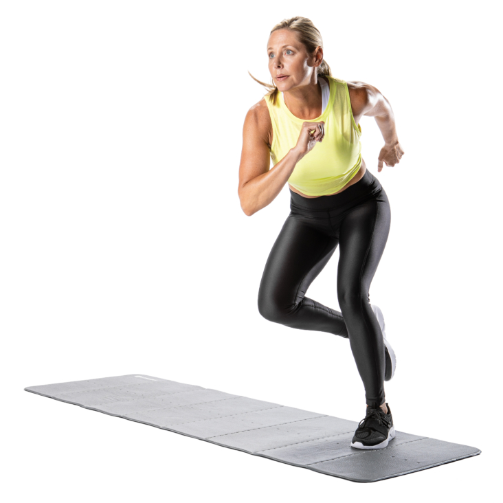 Woman jogging in place on exercise mat