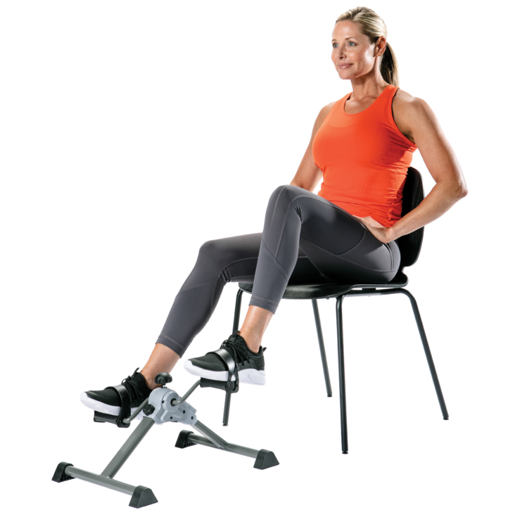 Seated woman pedaling a lower body cycle machine