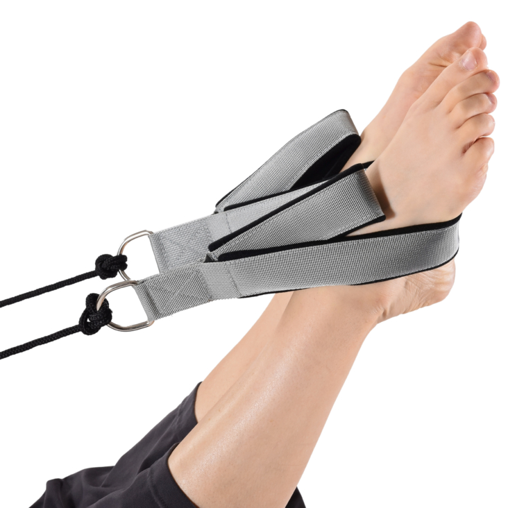 Close up for woman's bare feet in exercise straps