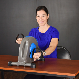 Woman in Blue Shirt Using Hand Rowing Machine